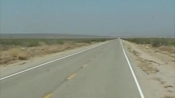 A Sultry Vision Halts A Desert Bus, Surrendering To The Raw, Unstoppable Heat That Claims Her Inside